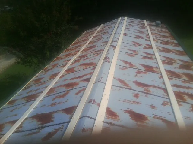 Rusted metal roof panels with new wood purlins before replacement — Storm Damage Roof Repair in Thurston by Roofing Brothers